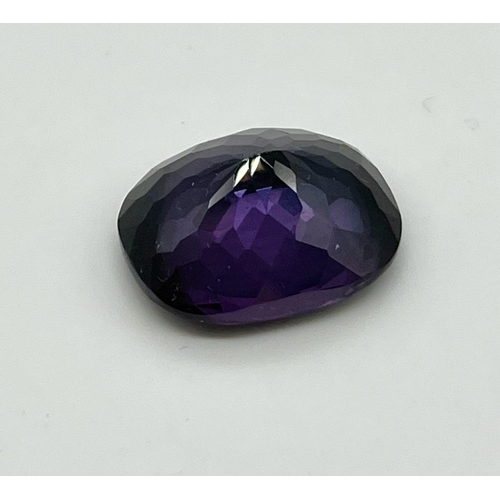 781 - A 23ct Purple-Coloured Oval Shape Gemstone. 20 x 18mm. No certificate so as found