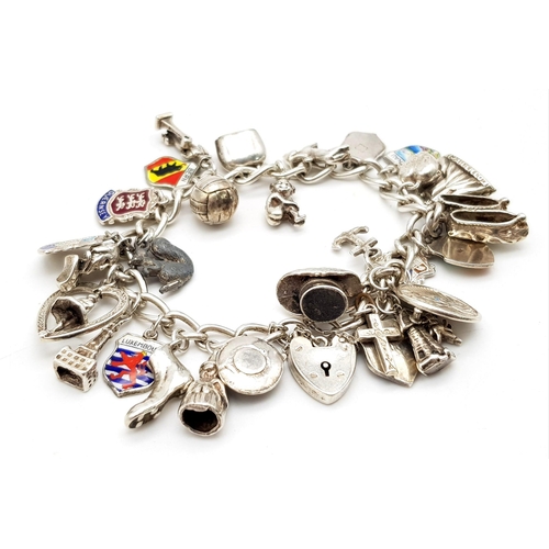 1314 - A Vintage Silver Charm Bracelet. 18cm. 65.7g total weight