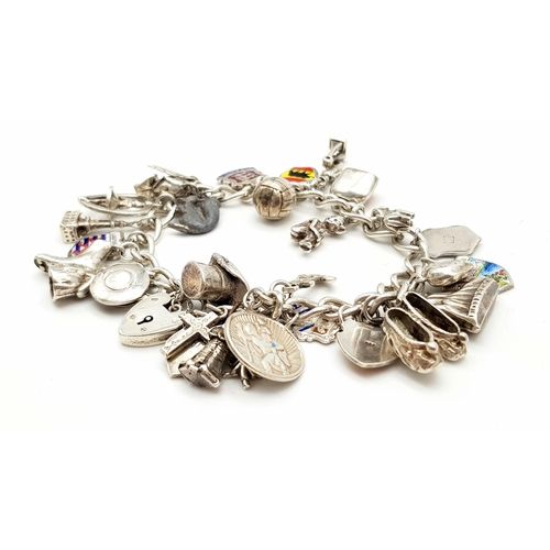 1314 - A Vintage Silver Charm Bracelet. 18cm. 65.7g total weight