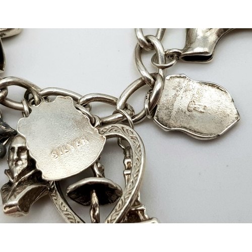 1314 - A Vintage Silver Charm Bracelet. 18cm. 65.7g total weight