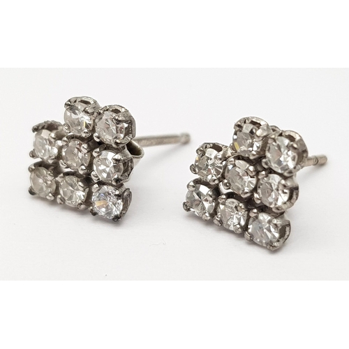 1233 - A 9K white gold pair of earrings with a cluster of fine diamonds. Total weight: 1.18 g.