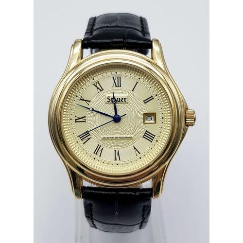 1340 - A Stauer Gents Dress Watch. Black leather strap. Two tone case - 40mm. Gold tone dial with date wind... 