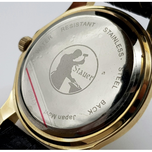 1340 - A Stauer Gents Dress Watch. Black leather strap. Two tone case - 40mm. Gold tone dial with date wind... 