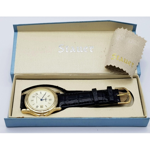 1340 - A Stauer Gents Dress Watch. Black leather strap. Two tone case - 40mm. Gold tone dial with date wind... 