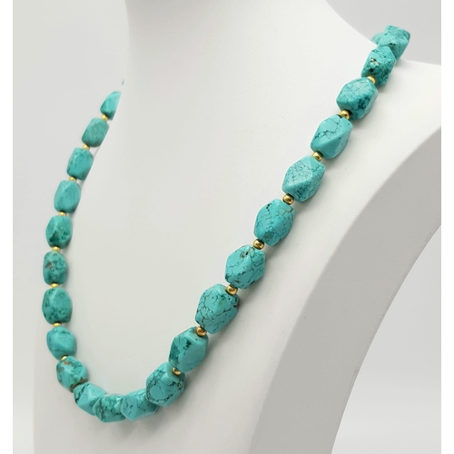 978 - A Blue Manganese Bead Necklace. With gilded spacers and magnetic clasp. 46cm.