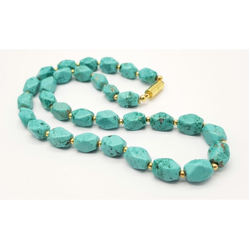 978 - A Blue Manganese Bead Necklace. With gilded spacers and magnetic clasp. 46cm.