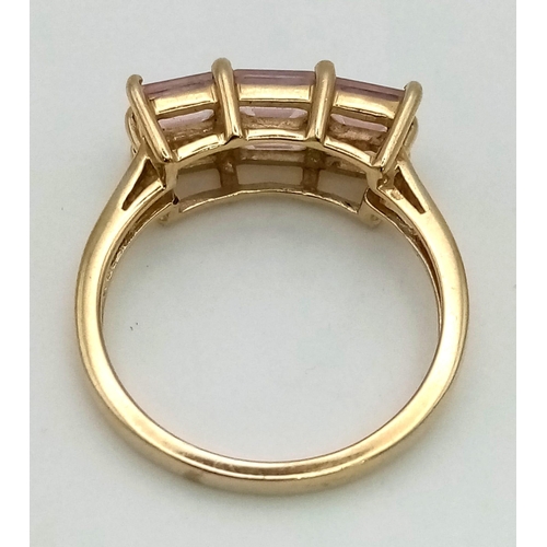 1016 - 9K YELLOW GOLD 6 PINK STONE RING. TOTAL WEIGHT 3G. SIZE N