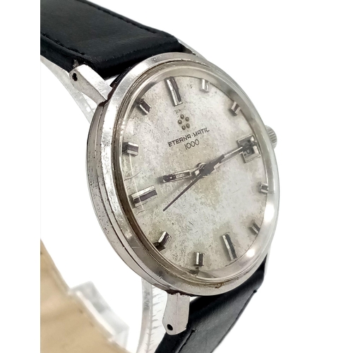 1406 - A Vintage Eterna-Matic 1000 Gents Watch. Black leather strap. Stainless steel case - 35mm. Silver to... 