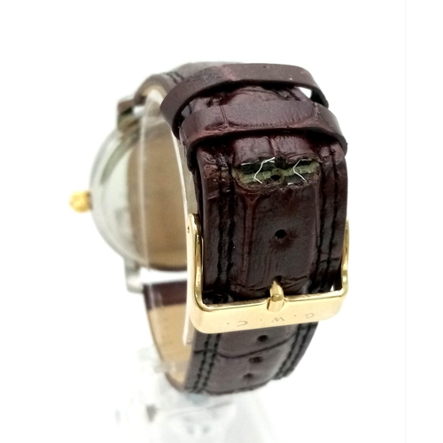 169 - A Geo Chatterton Gents Watch. Brown leather strap (broken). Two tone case - 45mm. Three tone dial wi... 