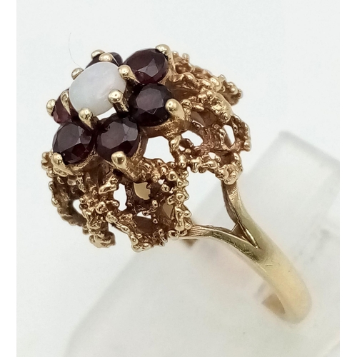 394 - 9K YELLOW GOLD GARNET & OPAL CLUSTER RING. WEIGHS  4G. SIZE K