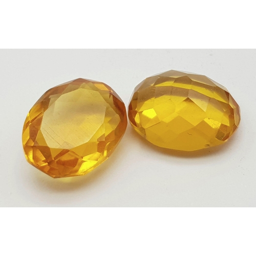 1076 - A Pair of 12ct (24ct) Orange/Cognac Coloured Faceted Oval Gemstones. 20 x 15mm. No visible marks. He... 