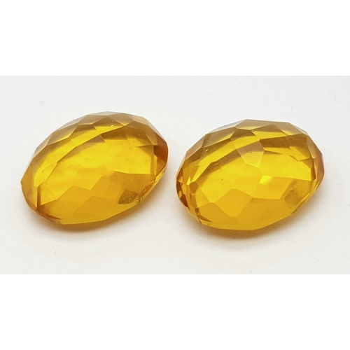 1076 - A Pair of 12ct (24ct) Orange/Cognac Coloured Faceted Oval Gemstones. 20 x 15mm. No visible marks. He... 