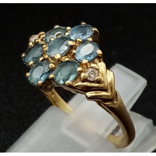 157 - 9K YELLOW GOLD, DIAMOND & TOPAZ FANCY CLUSTER RING. WEIGHS 3.1G.  SIZE M