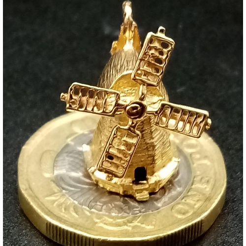 415 - 9K YELLOW GOLD WINDWILL WITH MOVING PARTS. WEIGHS 3.3G