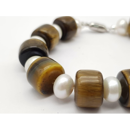 442 - A Tigers Eye and Pearl Bracelet. Tigers eye and cultured pear rondelles with a silver tone magnetic ... 