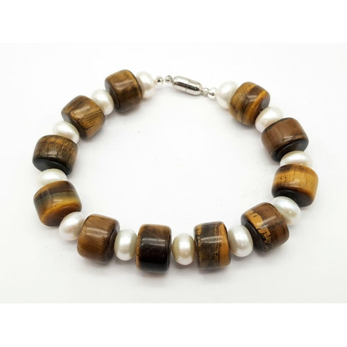 442 - A Tigers Eye and Pearl Bracelet. Tigers eye and cultured pear rondelles with a silver tone magnetic ... 