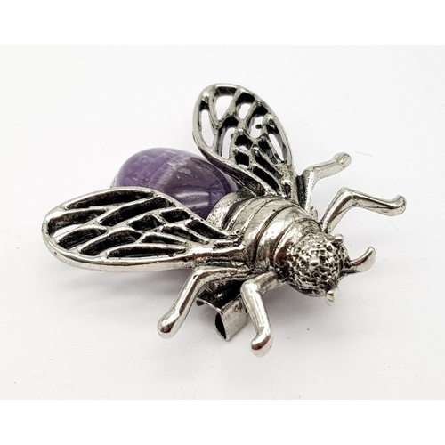 767 - An Amethyst and White Metal Bee Brooch. 4cm wingspan.