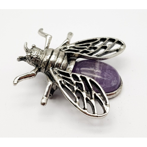 767 - An Amethyst and White Metal Bee Brooch. 4cm wingspan.