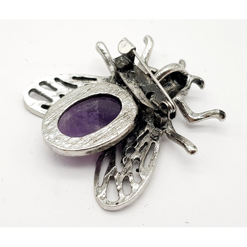 767 - An Amethyst and White Metal Bee Brooch. 4cm wingspan.