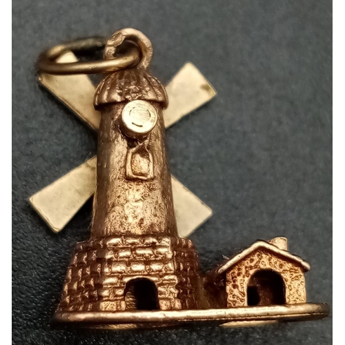 830 - 9K WINDMILL CHARM WITH SPINNING WHEEL. TOTAL WEIGHT 3.2G