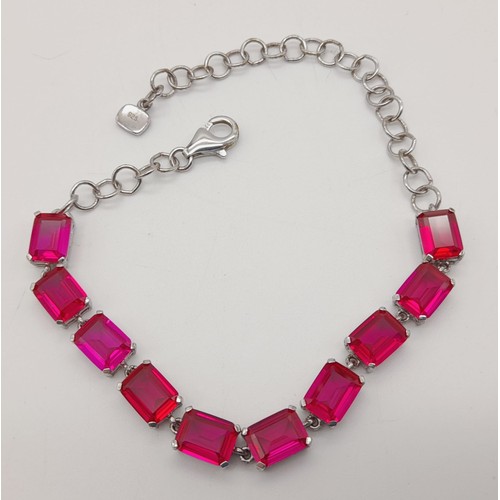 1325 - A New Sterling Silver and Synthetic Ruby Tennis Bracelet 20cm Length,

Weight 10 grams. In Presentat... 