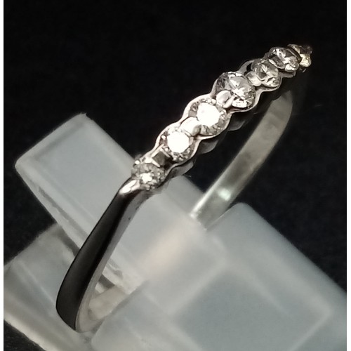 516 - 18K WHITE GOLD DIAMOND BAND RING. 0.20CT DIAMOND. TOTAL WEIGHT 2.3G. SIZE R/S