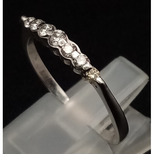 516 - 18K WHITE GOLD DIAMOND BAND RING. 0.20CT DIAMOND. TOTAL WEIGHT 2.3G. SIZE R/S