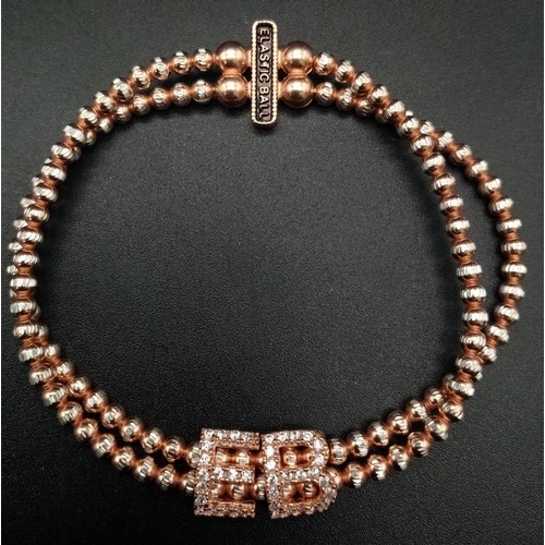 1117 - STERLIGN SILVER WITH ROSE GOLD VERMEIL STONE SET ELASTICATED BRACELET. WEIGHT 15.4G