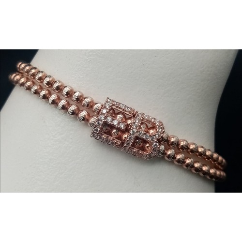 1117 - STERLIGN SILVER WITH ROSE GOLD VERMEIL STONE SET ELASTICATED BRACELET. WEIGHT 15.4G