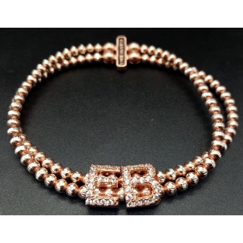 1117 - STERLIGN SILVER WITH ROSE GOLD VERMEIL STONE SET ELASTICATED BRACELET. WEIGHT 15.4G