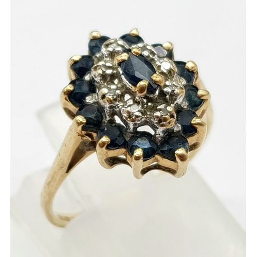 699 - 9K YELLOW GOLD DIAMOND & SAPPHIRE CLUSTER RING. WEIGHS 2G.  SIZE K/L