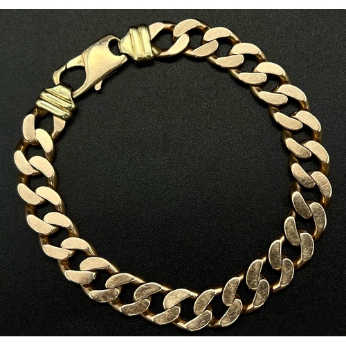 74 - A Heavy 9K Yellow Gold Flat Curb Link Gents Bracelet. 24cm.
54.05g.