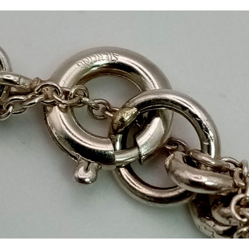 228 - A Vintage 925 Silver Charm Bracelet. Over 20 eclectic charms
including a horse shoe and rocking hors... 