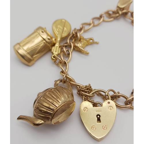 96 - A 9K Yellow Gold Charm Bracelet with Heart Clasp. 10 charms including the Cat and the Fiddle! 18cm. ... 