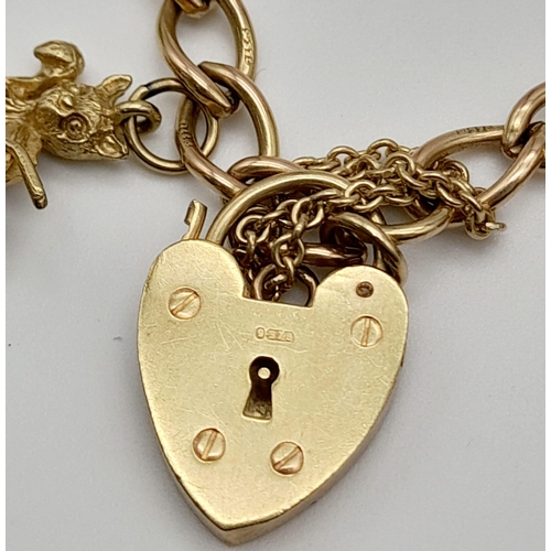 96 - A 9K Yellow Gold Charm Bracelet with Heart Clasp. 10 charms including the Cat and the Fiddle! 18cm. ... 