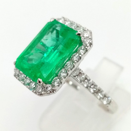 90 - A 950 Platinum 6.19ct Colombian Emerald and Diamond Ring. Octagonal mixed cut emerald with a diamond... 