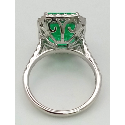 90 - A 950 Platinum 6.19ct Colombian Emerald and Diamond Ring. Octagonal mixed cut emerald with a diamond... 