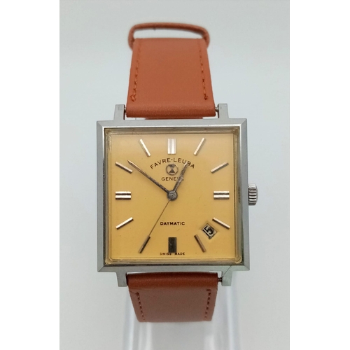 199 - A Vintage Favre-Leuba Daymatic Watch. Brown leather strap. Square case - 30mm. Peach dial with date ... 