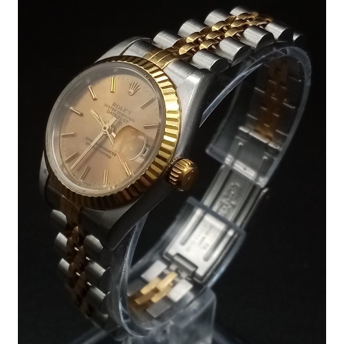 166 - A Rolex Oyster Perpetual Datejust Ladies Watch. Bi-metal strap and case - 26mm. Gold tone dial with ... 