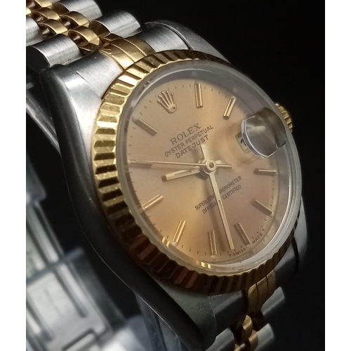 166 - A Rolex Oyster Perpetual Datejust Ladies Watch. Bi-metal strap and case - 26mm. Gold tone dial with ... 