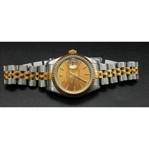 166 - A Rolex Oyster Perpetual Datejust Ladies Watch. Bi-metal strap and case - 26mm. Gold tone dial with ... 