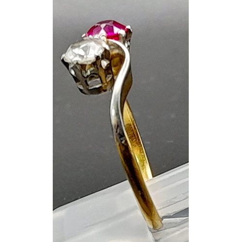 153 - A Glorious 18K Yellow Gold Ruby and Diamond Crossover Ring. A beautiful clean round cut (0.6ct each)... 