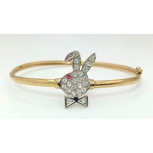 1006 - A 9K yellow gold, stone set, Playboy bunny bangle with safety catch. Weight: 4.5 g.