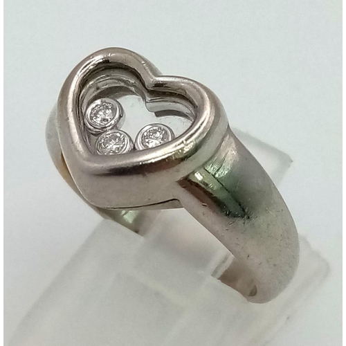 566 - An 18 K white gold diamond set heart ring with floating diamonds. Ring size: M, weight: 9.1 g.