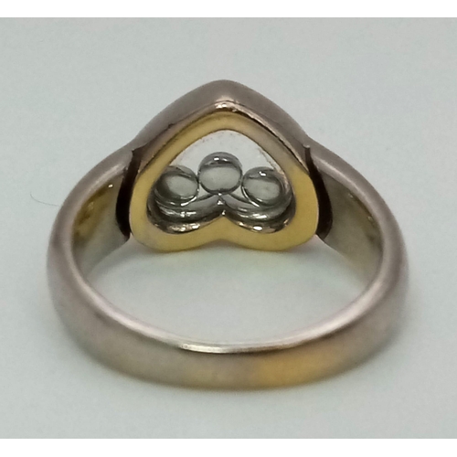 566 - An 18 K white gold diamond set heart ring with floating diamonds. Ring size: M, weight: 9.1 g.