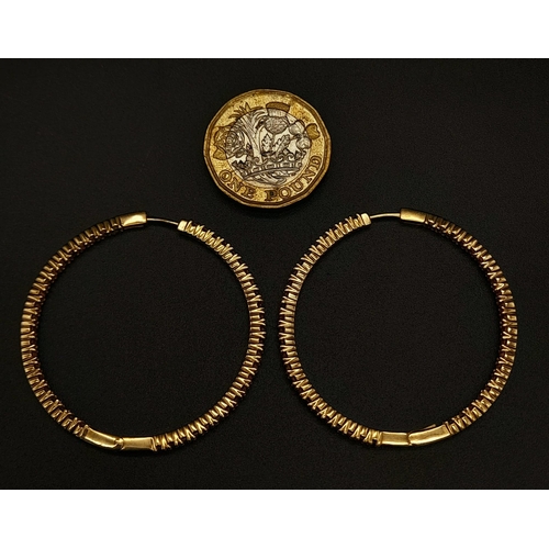 121 - A 9 K yellow gold, pink stone set, hoop earrings, weight: 8.4 g.