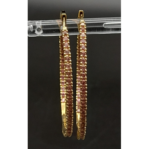 121 - A 9 K yellow gold, pink stone set, hoop earrings, weight: 8.4 g.