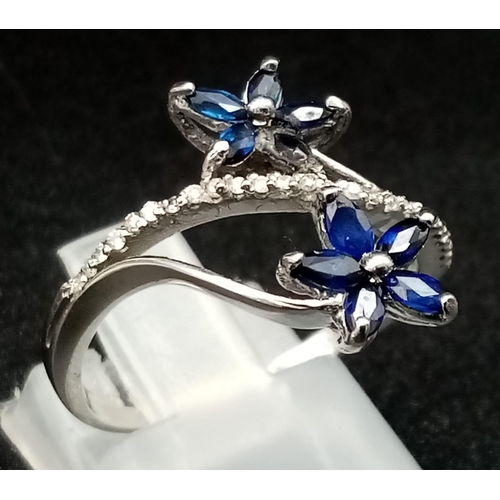 990 - An 18K White Gold Diamond and Sapphire Floral Burst Ring. 3.35g total weight. Size M/N.