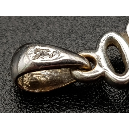 191 - An 18 K white gold, diamond set, pair of swans in a heart shaped pendant/charm. Weight: 2.2. g.