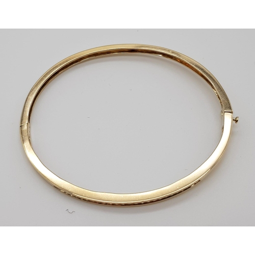 107 - 9K YELLOW GOLD DIAMOND SET BANGLE WITH SAFETY CATCH 0.40CT 9.9G